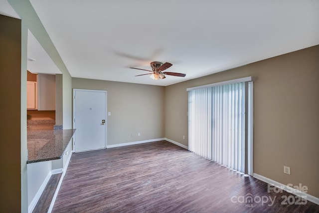 809 High Meadow Ln Unit F, Charlotte, NC 28217 - unfurnished living room with dark wood-type flooring, ceiling fan, and baseboards
