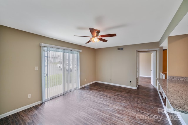 809 High Meadow Ln Unit F, Charlotte, NC 28217 - spare room featuring a ceiling fan, dark wood-type flooring, and baseboards