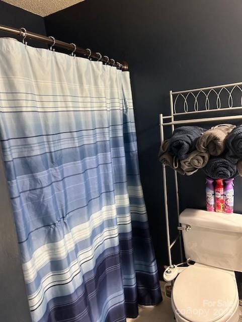 114 Wayne Ave, Kannapolis, NC 28081 - bathroom featuring toilet and a shower with shower curtain