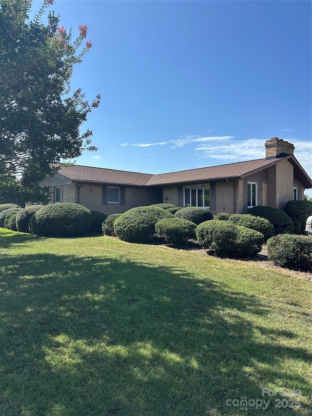 1410 Patterson St, China Grove, NC 28023 - view of front of home with a front lawn and a chimney
