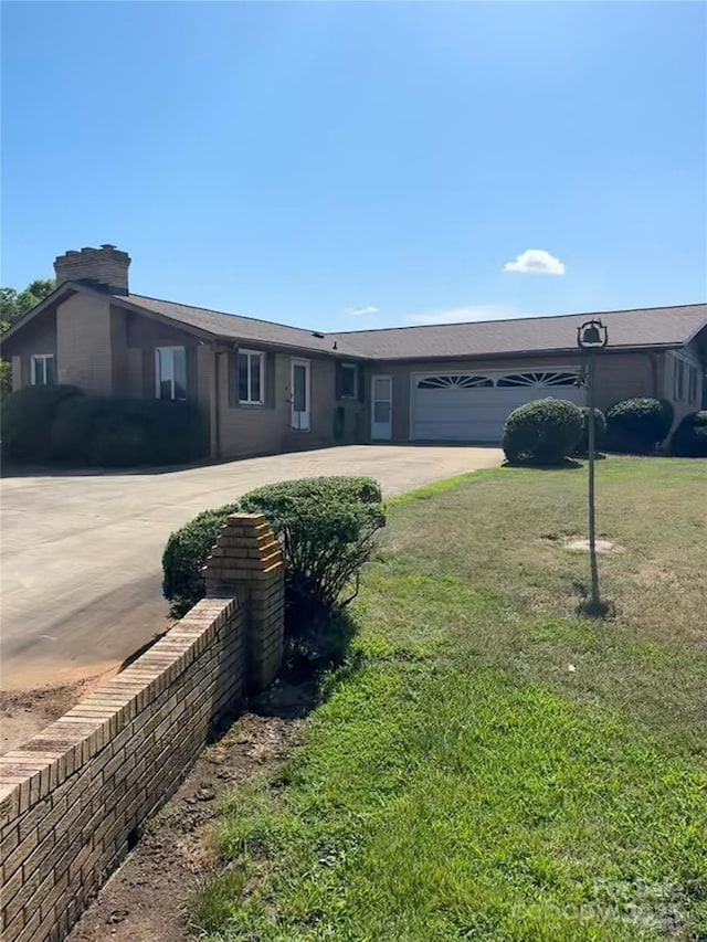 1410 Patterson St, China Grove, NC 28023 - ranch-style home featuring concrete driveway, an attached garage, and a front yard