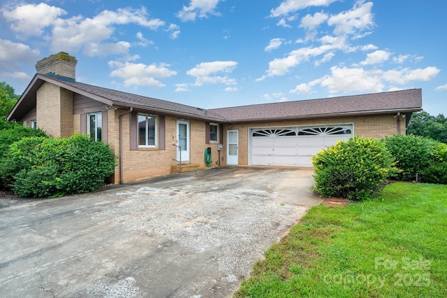1410 Patterson St, China Grove, NC 28023 - ranch-style house featuring brick siding, concrete driveway, a chimney, and a garage