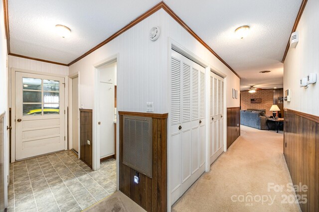1410 Patterson St, China Grove, NC 28023 - corridor featuring ornamental molding, a textured ceiling, wooden walls, and heating unit