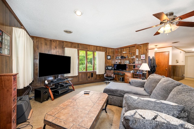 1410 Patterson St, China Grove, NC 28023 - living room featuring wooden walls, crown molding, ceiling fan, and light carpet