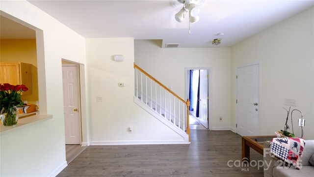 7046 Dorn Cir, Charlotte, NC 28212 - foyer featuring stairs, wood finished floors, ceiling fan, and baseboards