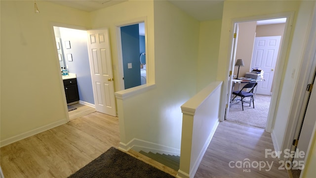 7046 Dorn Cir, Charlotte, NC 28212 - hall with an upstairs landing, light wood finished floors, and baseboards