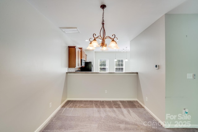 9800 Walkers Glen Dr NW, Concord, NC 28027 - unfurnished dining area with a chandelier, baseboards, and carpet flooring