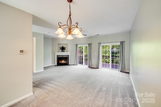 9800 Walkers Glen Dr NW, Concord, NC 28027 - unfurnished living room featuring carpet floors, baseboards, a chandelier, and a fireplace with flush hearth