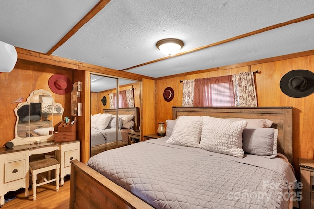 2289 Mccloud St, Denver, NC 28037 - bedroom featuring wooden walls, wood finished floors, a textured ceiling, and a closet