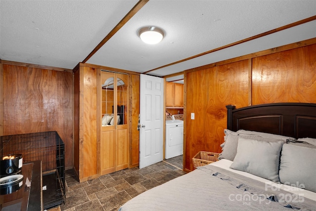 2289 Mccloud St, Denver, NC 28037 - bedroom with washing machine and clothes dryer, dark stone finish flooring, a textured ceiling, wood walls, and a closet