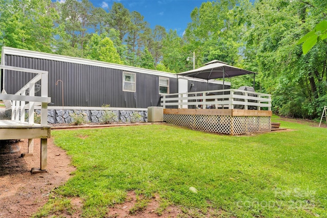 2289 Mccloud St, Denver, NC 28037 - back of house featuring a wooden deck, a lawn, and central AC