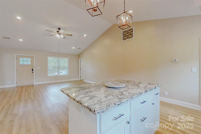 108 Devynne Ct, Salisbury, NC 28146 - kitchen with light wood-style floors, a center island, a ceiling fan, lofted ceiling, and decorative light fixtures