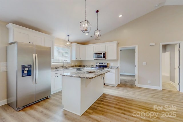 108 Devynne Ct, Salisbury, NC 28146 - kitchen with stainless steel appliances, a center island, white cabinetry, light wood finished floors, and recessed lighting