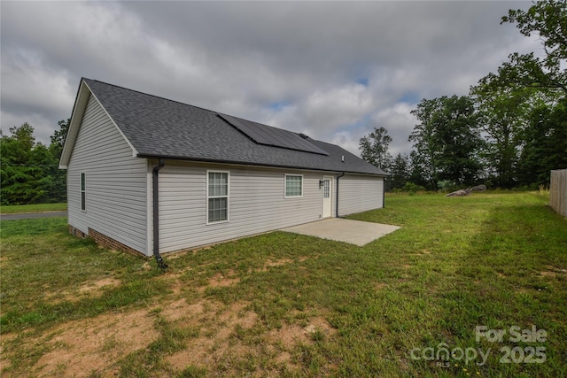 108 Devynne Ct, Salisbury, NC 28146 - rear view of property with solar panels, a shingled roof, a patio area, and a yard