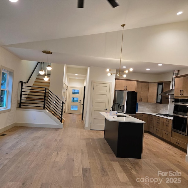 30 Sand Hill Rd, Asheville, NC 28806 - kitchen featuring appliances with stainless steel finishes, light countertops, a sink, tasteful backsplash, and pendant lighting