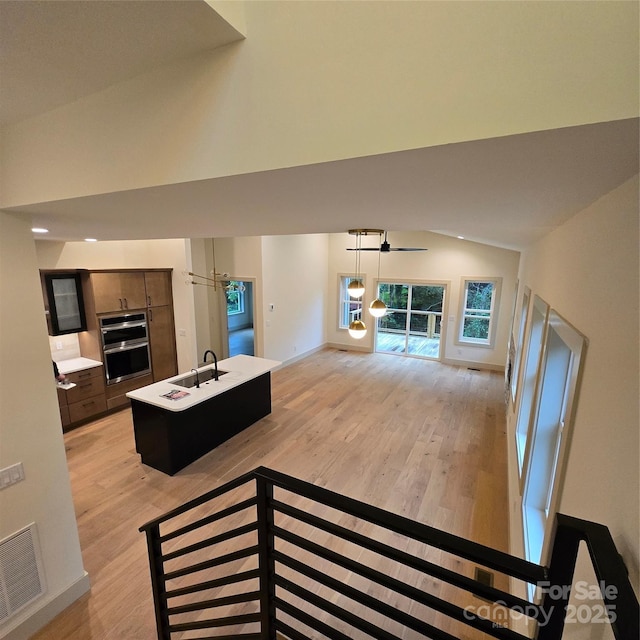 30 Sand Hill Rd, Asheville, NC 28806 - living room featuring vaulted ceiling, light wood-style flooring, a ceiling fan, and baseboards