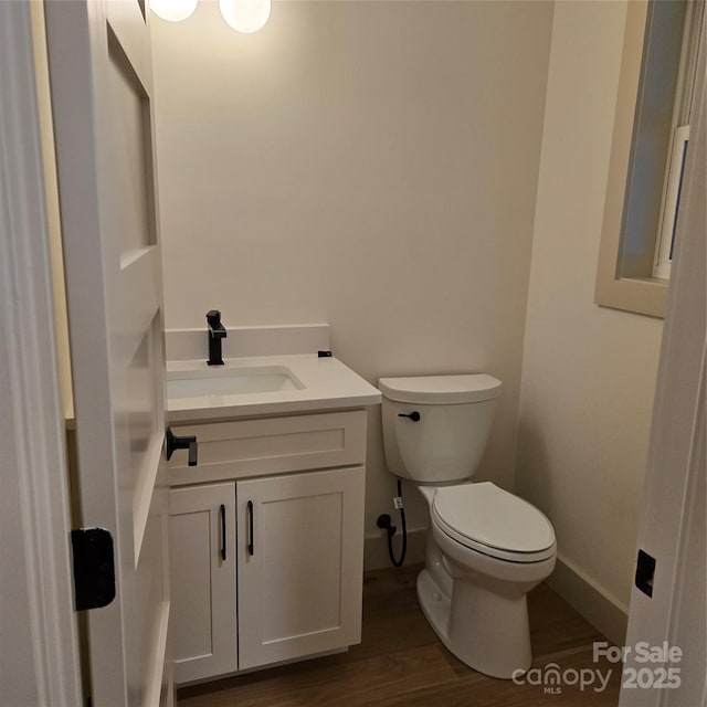 30 Sand Hill Rd, Asheville, NC 28806 - half bathroom with toilet, vanity, wood finished floors, and baseboards