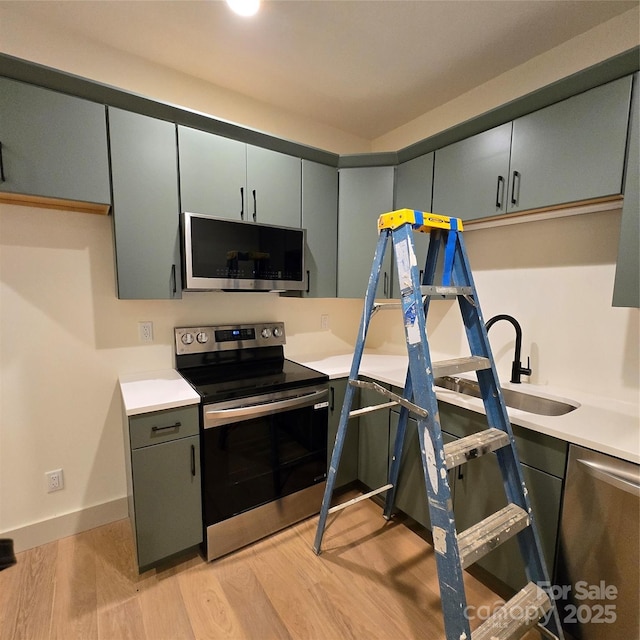 30 Sand Hill Rd, Asheville, NC 28806 - kitchen featuring appliances with stainless steel finishes, light wood-type flooring, and light countertops