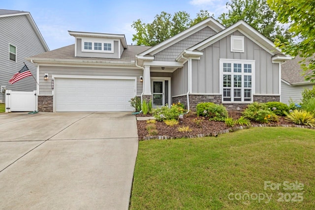 219 Broadleaf Dr, Denver, NC 28037 - craftsman house with board and batten siding, stone siding, driveway, a garage, and a front yard