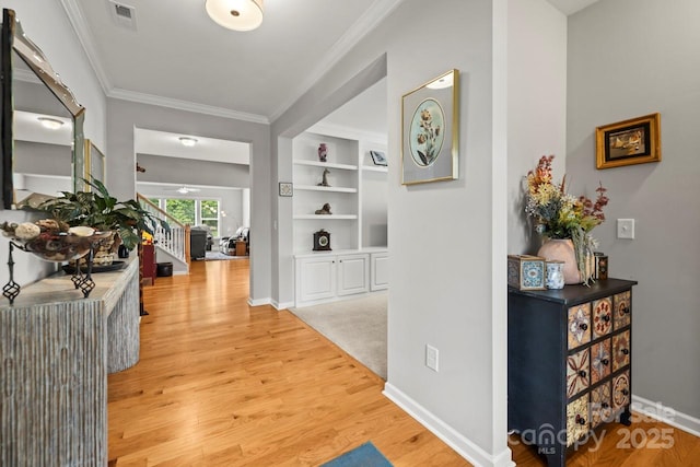 219 Broadleaf Dr, Denver, NC 28037 - hall featuring ornamental molding, light wood-type flooring, baseboards, and built in features