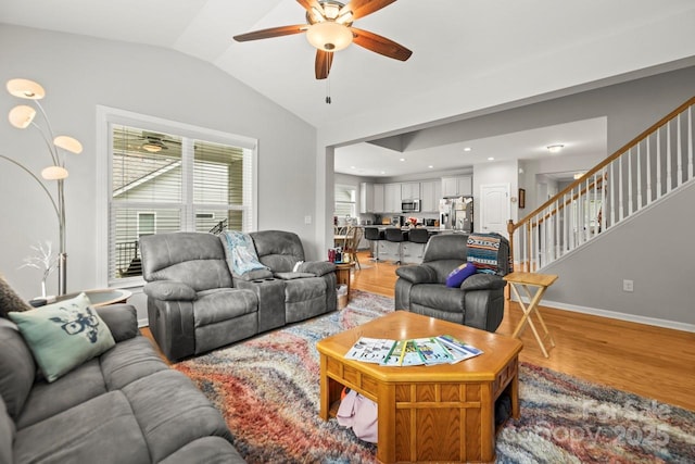219 Broadleaf Dr, Denver, NC 28037 - living room featuring stairway, a ceiling fan, lofted ceiling, light wood-style floors, and baseboards