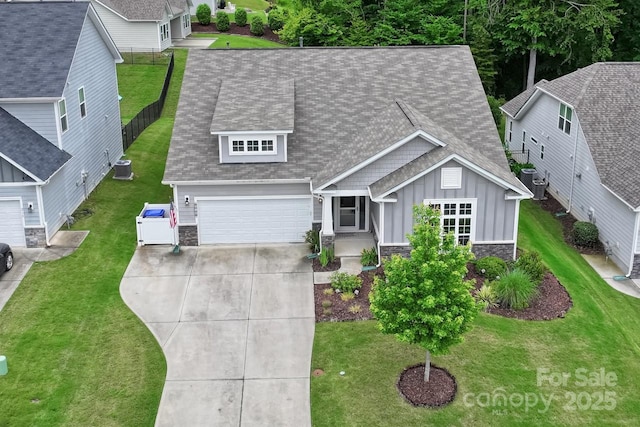 219 Broadleaf Dr, Denver, NC 28037 - view of front of house with board and batten siding, concrete driveway, stone siding, a shingled roof, and a front yard