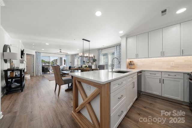18679 Vineyard Point Ln, Cornelius, NC 28031 - kitchen featuring a sink, stainless steel dishwasher, open floor plan, a peninsula, and healthy amount of natural light