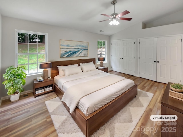 12307 Poplar Forest Dr, Charlotte, NC 28278 - bedroom featuring multiple windows, light wood finished floors, multiple closets, vaulted ceiling, and ceiling fan