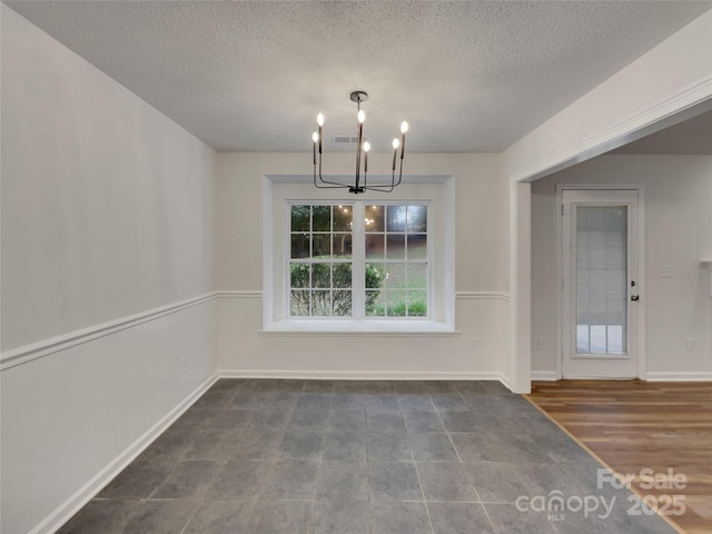 12307 Poplar Forest Dr, Charlotte, NC 28278 - unfurnished dining area with a chandelier, a textured ceiling, and baseboards