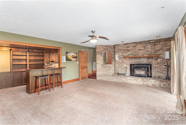 1227 Brush Creek Cir, Fairview, NC 28730 - living area featuring carpet flooring, bar, a ceiling fan, baseboards, and a textured ceiling