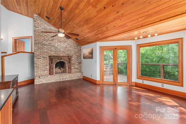 1227 Brush Creek Cir, Fairview, NC 28730 - unfurnished living room featuring lofted ceiling, ceiling fan, wood ceiling, wood finished floors, and a brick fireplace
