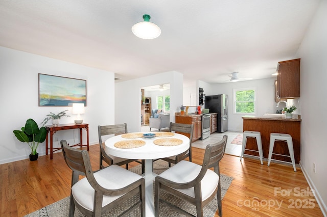 205 Cowan Cove Rd, Asheville, NC 28806 - dining room with ceiling fan, light wood-style flooring, and baseboards