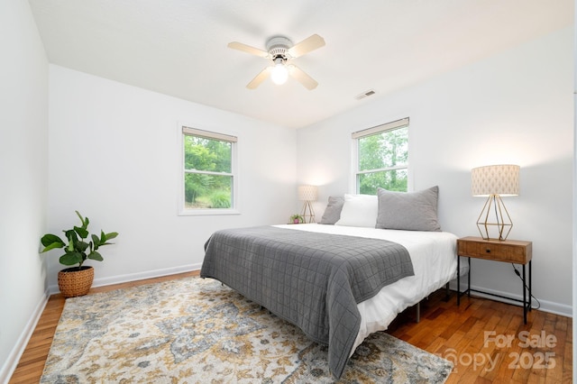 205 Cowan Cove Rd, Asheville, NC 28806 - bedroom with multiple windows, wood finished floors, baseboards, and ceiling fan