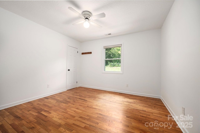 205 Cowan Cove Rd, Asheville, NC 28806 - empty room featuring wood finished floors, a ceiling fan, baseboards, and a textured ceiling