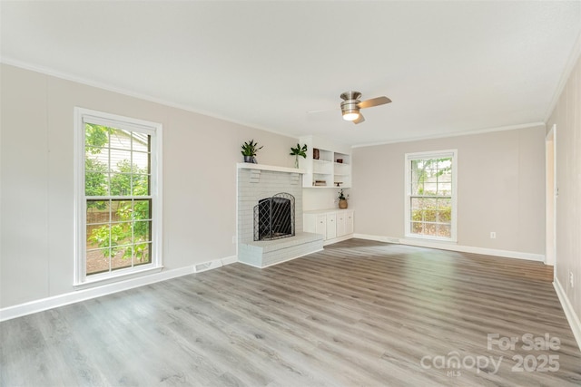 14027 Hackamore Dr, Matthews, NC 28105 - unfurnished living room with crown molding, wood finished floors, a brick fireplace, and ceiling fan