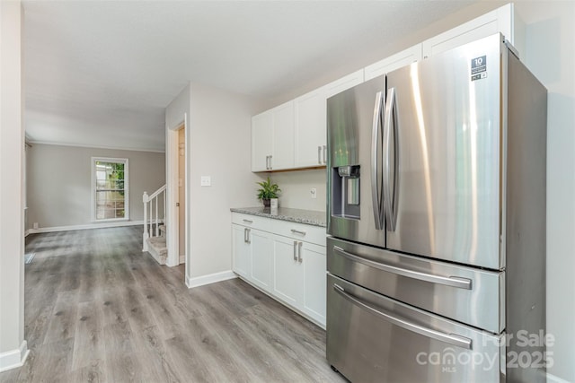 14027 Hackamore Dr, Matthews, NC 28105 - kitchen featuring stainless steel fridge with ice dispenser, white cabinets, light stone counters, and light wood-style floors
