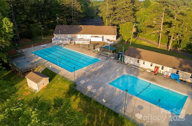 14027 Hackamore Dr, Matthews, NC 28105 - community pool featuring a patio, an outdoor structure, and a forest view
