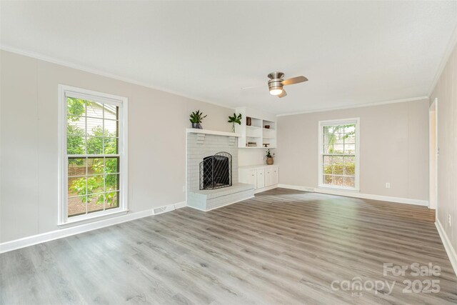 14027 Hackamore Dr, Matthews, NC 28105 - unfurnished living room with ornamental molding, wood finished floors, a fireplace, and a ceiling fan