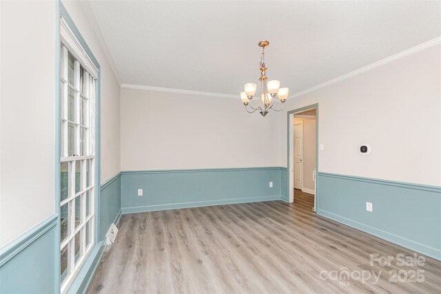 14027 Hackamore Dr, Matthews, NC 28105 - empty room featuring a chandelier, ornamental molding, and wood finished floors