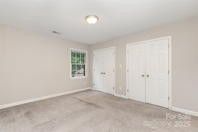 14027 Hackamore Dr, Matthews, NC 28105 - unfurnished bedroom with two closets and carpet flooring