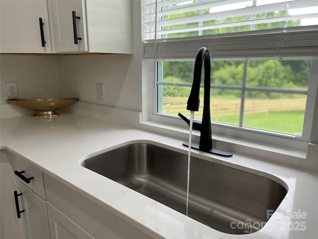 117 Autumn Woods Dr, Kings Mountain, NC 28086 - kitchen view of a sink, white cabinetry, and light stone countertops