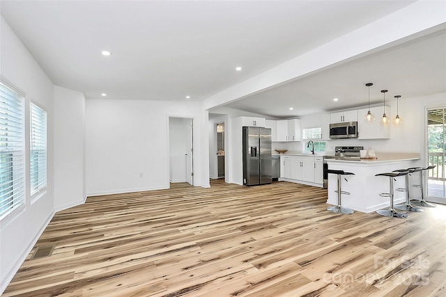 117 Autumn Woods Dr, Kings Mountain, NC 28086 - kitchen featuring appliances with stainless steel finishes, light wood-style flooring, light countertops, white cabinetry, and recessed lighting