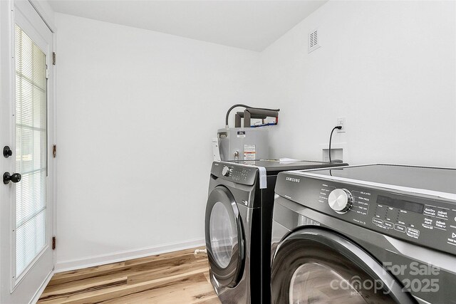 117 Autumn Woods Dr, Kings Mountain, NC 28086 - washroom with washer and dryer, gas water heater, light wood-style flooring, and plenty of natural light