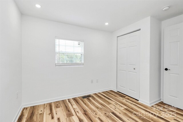 117 Autumn Woods Dr, Kings Mountain, NC 28086 - unfurnished bedroom featuring light wood-type flooring, a closet, and recessed lighting