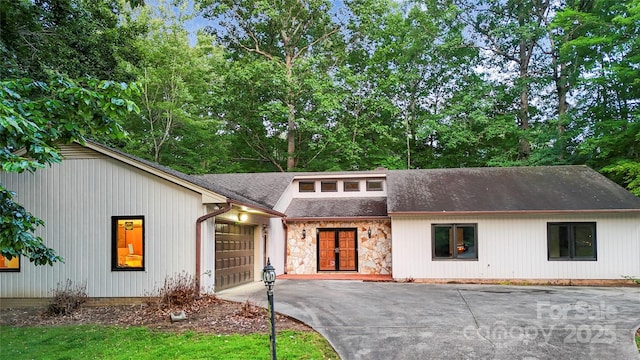 1700 Abbottsford Dr, Kernersville, NC 27284 - view of front of property featuring driveway, a garage, stone siding, roof with shingles, and french doors