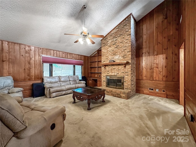 1700 Abbottsford Dr, Kernersville, NC 27284 - living area with wooden walls, ceiling fan, vaulted ceiling, a textured ceiling, and built in features