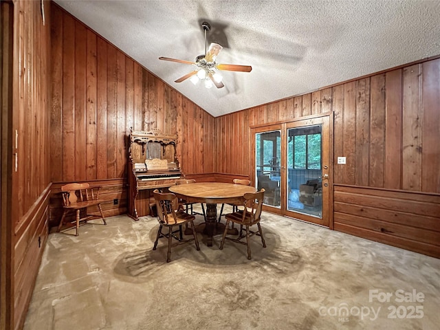 1700 Abbottsford Dr, Kernersville, NC 27284 - carpeted dining space featuring wood walls, a ceiling fan, a textured ceiling, and vaulted ceiling