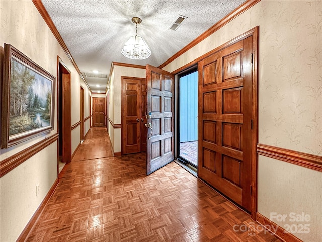 1700 Abbottsford Dr, Kernersville, NC 27284 - foyer featuring a chandelier, crown molding, a textured ceiling, and baseboards