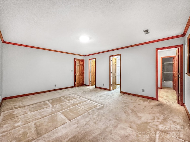 1700 Abbottsford Dr, Kernersville, NC 27284 - unfurnished bedroom with crown molding, carpet, baseboards, a textured ceiling, and a walk in closet