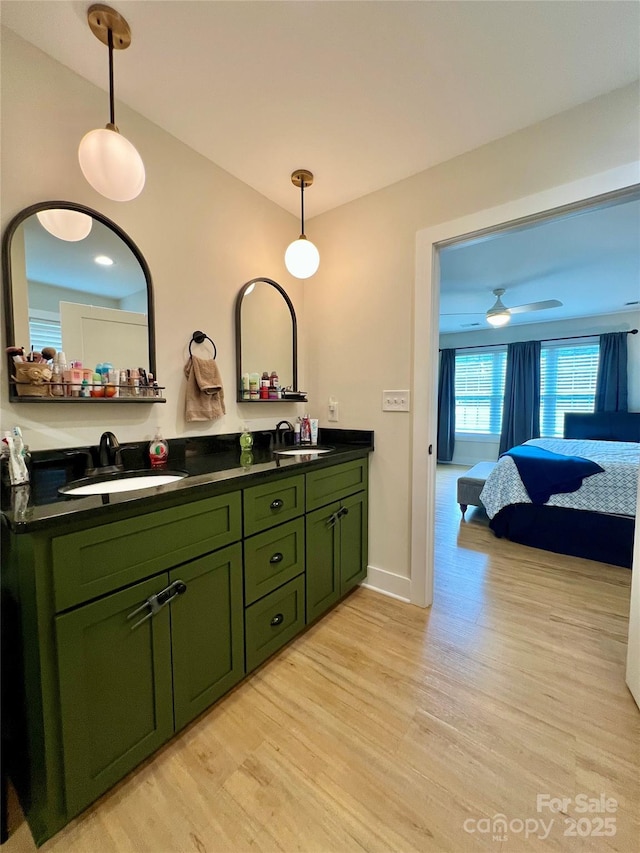7133 Church Rd, Taylorsville, NC 28681 - ensuite bathroom with wood finished floors, double vanity, and baseboards
